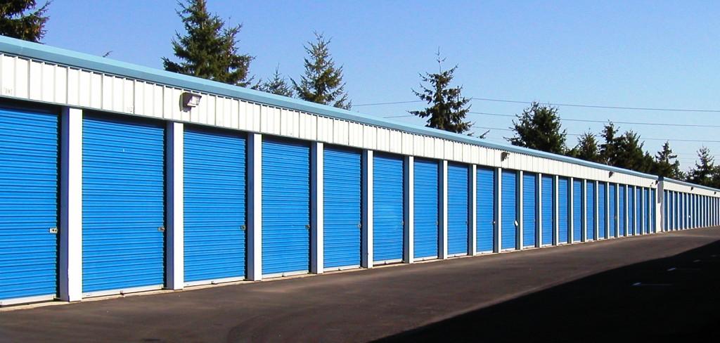 Long row of storage units with blue rolling doors