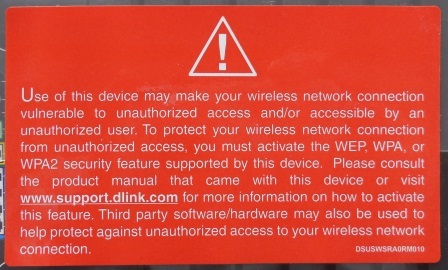 Orange security Warning Label packed with a D-Link Wi-Fi Router, warning not to use the default security settings.