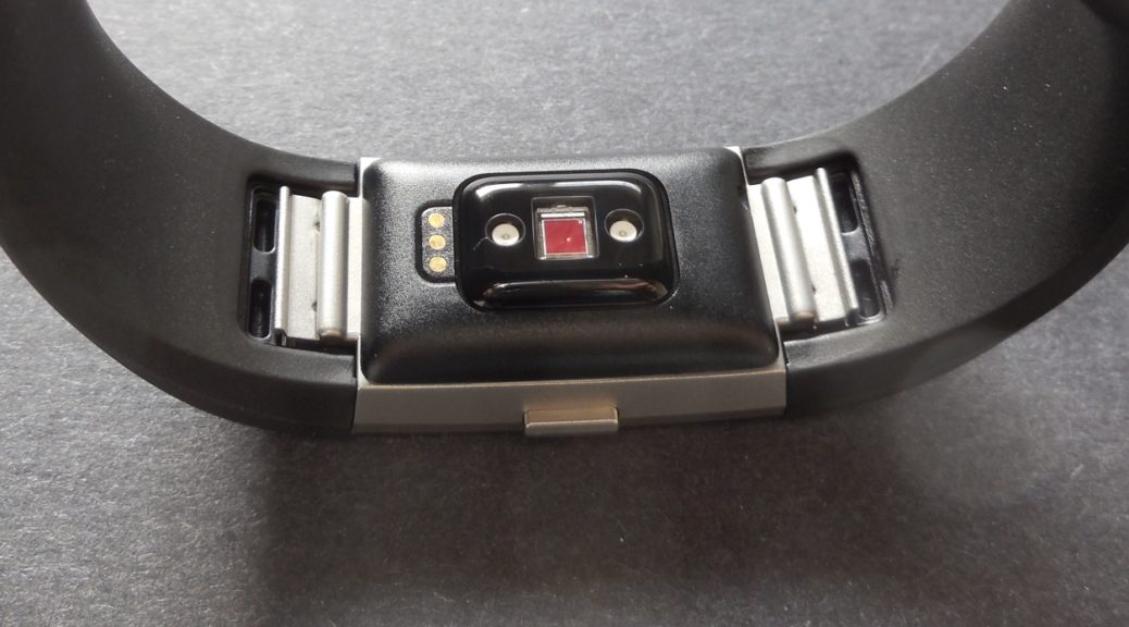 Bottom view of a Fitbit Charge 2 fitness band, showing the charging contacts and pulse sensor