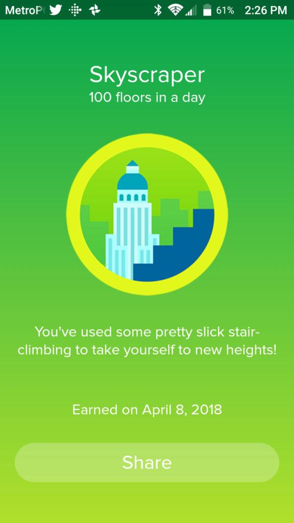 The Fitbit app generated this Skyscraper badge when the fitness band recorded climbing 100 floors in a day. The text says "You've used some pretty slick stair-climbing to take yourself to new heights!"